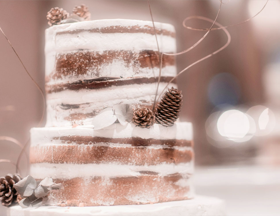decorated layered cake with dried leaves and pine cones